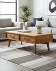 Modern living room with gray sofa, wooden coffee table, and abstract art on wall.