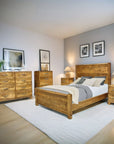 Wooden bedroom furniture set with bed, dressers, and nightstands in a room.