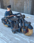 Vintage toy motorcycle with a rider on a wooden surface