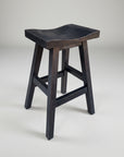 A black Yukon saddle stool with square legs and a scooped seat, made of solid wood.