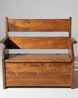 A rustic wooden deacon's bench with a lift-up seat revealing storage space, featuring a standard wood texture.
