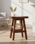 A brown wooden timber stool with a scooped seat and bolt accents, Canadian-made.