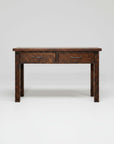 A rustic dark brown wooden writing desk with two drawers and dark metal handles, shown against a plain white background.