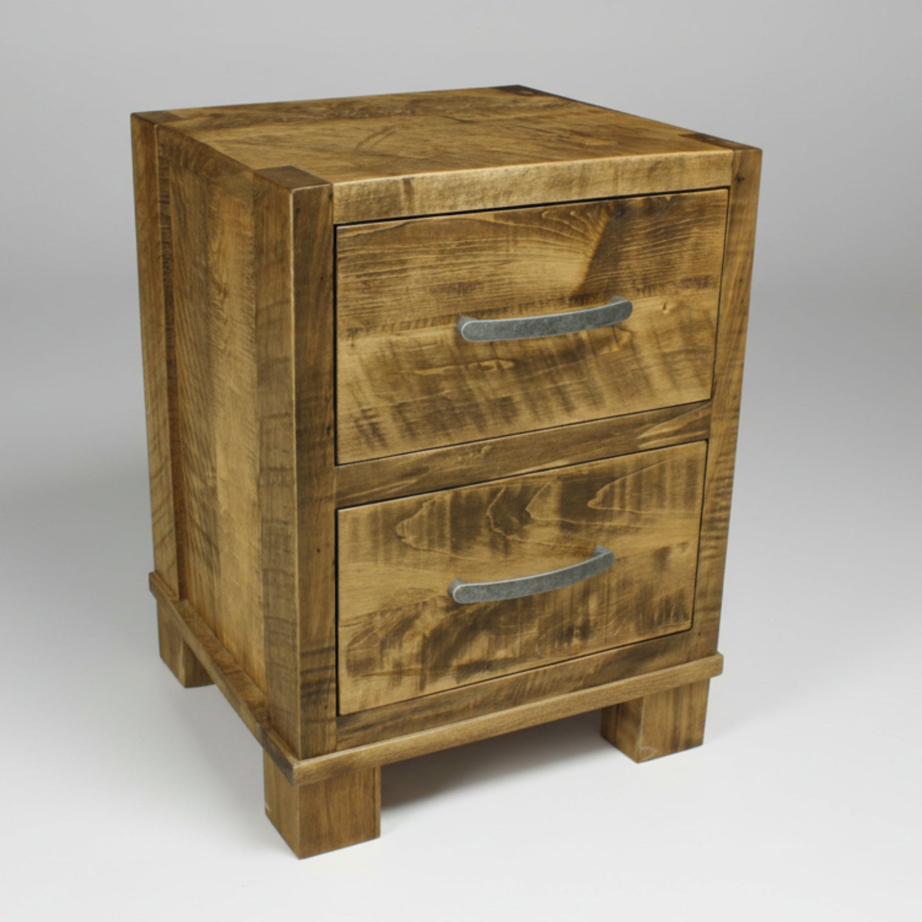 A rustic brown wooden nightstand with two drawers and metal handles, on a solid white background.