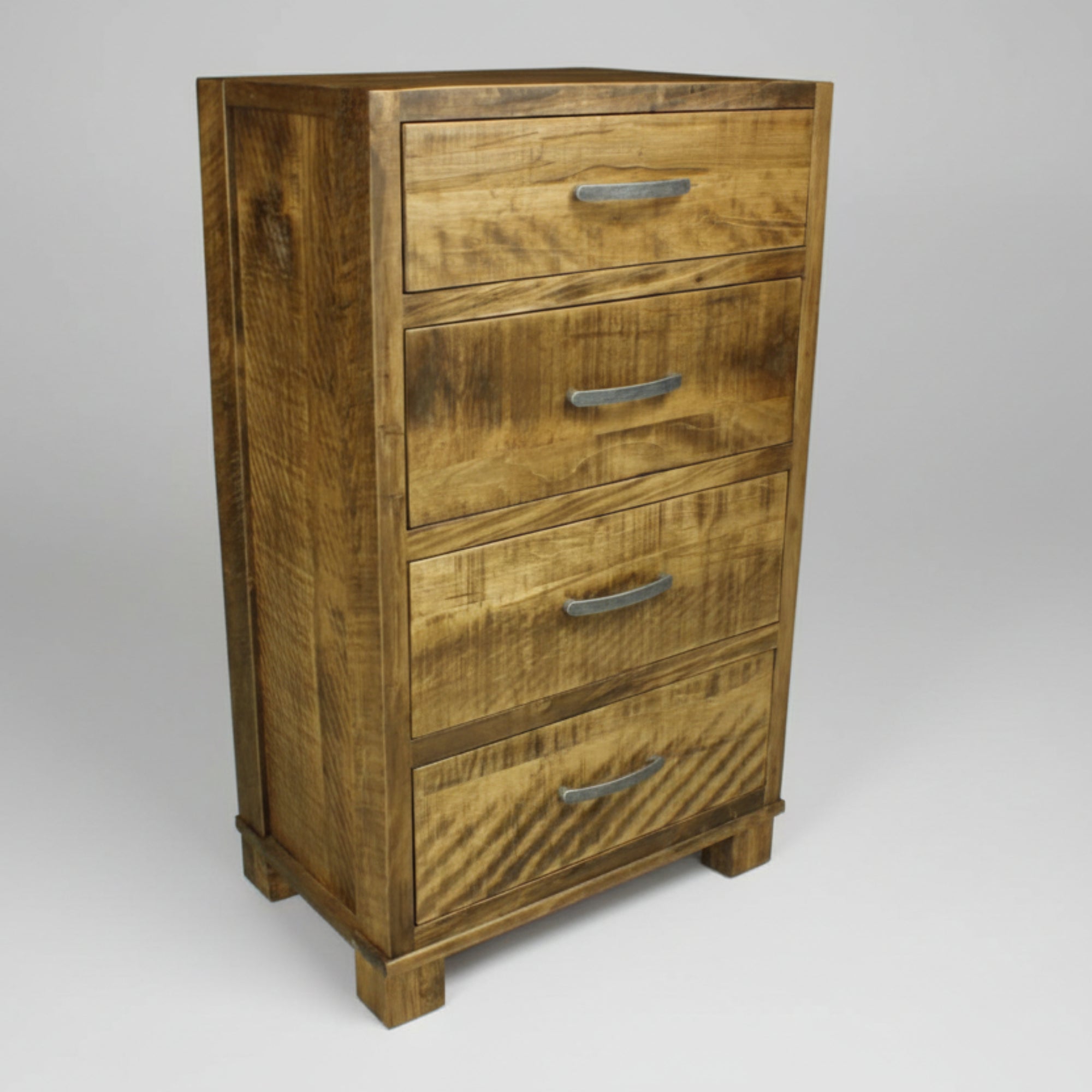 A Canadian-made handcrafted Backwoods Dresser with four drawers, featuring a Millsawn texture and metal drawer pulls.