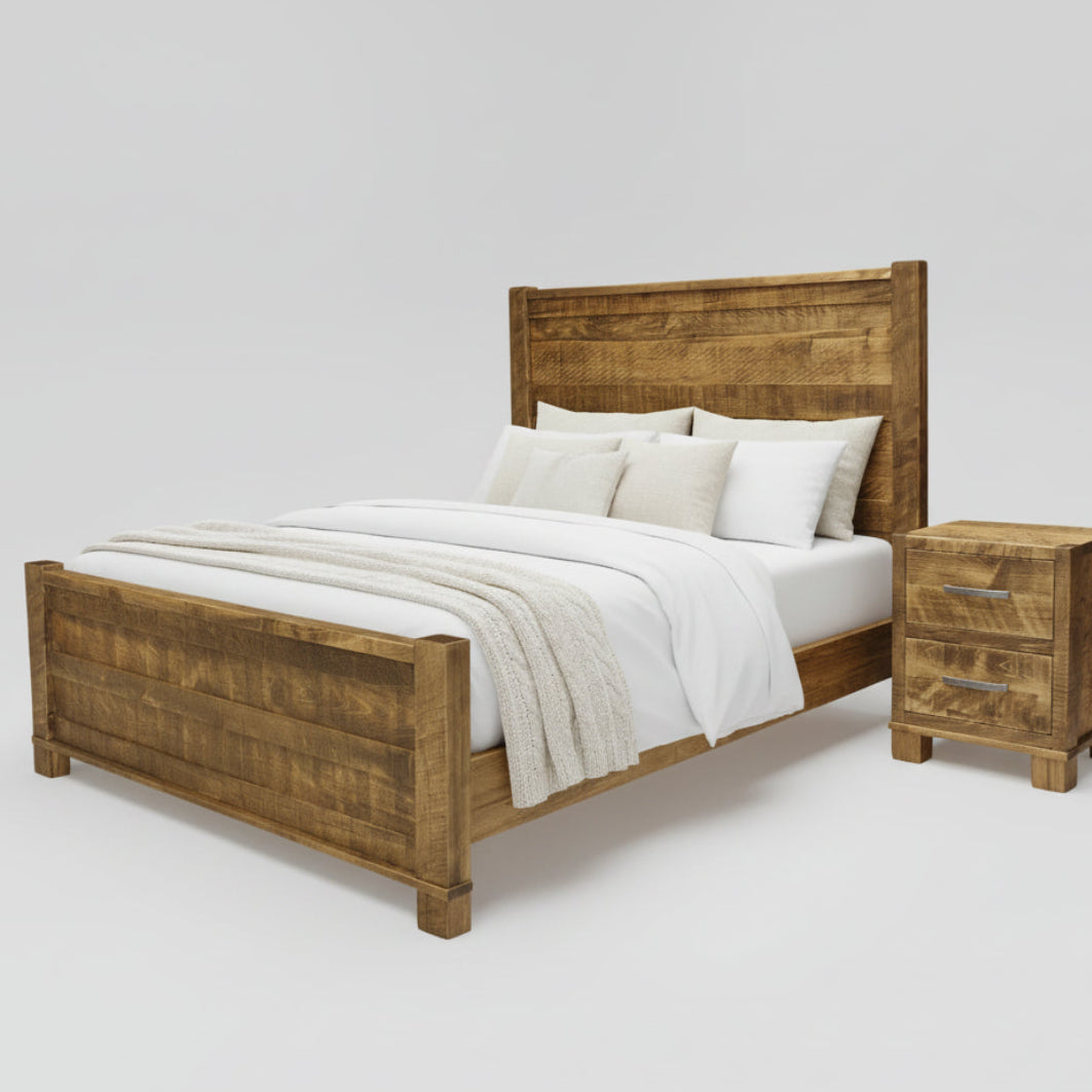 A rustic, Canadian-made wooden bed frame with a headboard and footboard, displayed in a room setting with bedding and a nightstand.