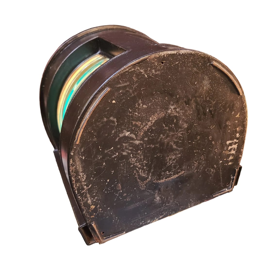 A vintage, heavily worn brown plastic half-cylinder container or spool, shown at an angle on a plain white background.