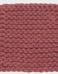 Canyon rose handmade knitted pot holder on a white background