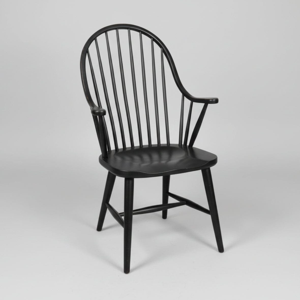 Black wooden chair with spindle back on a white background