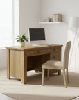 A rustic Dakota student desk made of solid wood with a visible circular saw mark texture on the top. The desk features multiple drawers and a natural wood finish.