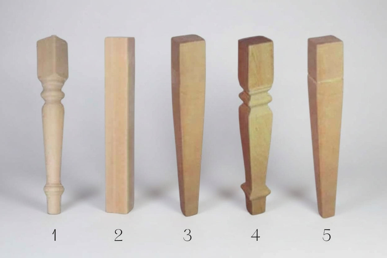 Five wooden furniture legs of different designs and finishes on a white background.