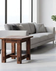 Wooden side table with a dark brown finish on a white background