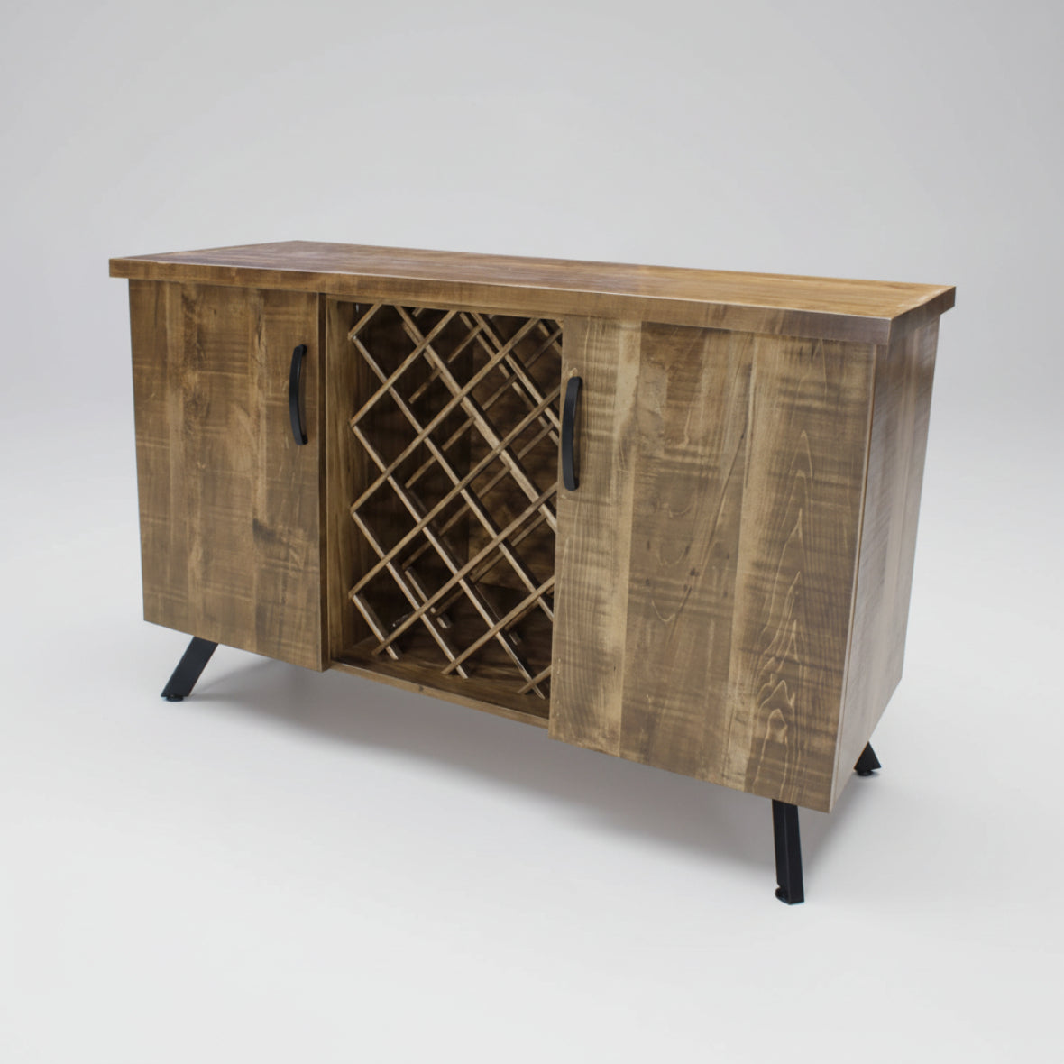 A wooden Maxwell Sideboard with two doors and a wine rack, featuring sleek metal accent legs.