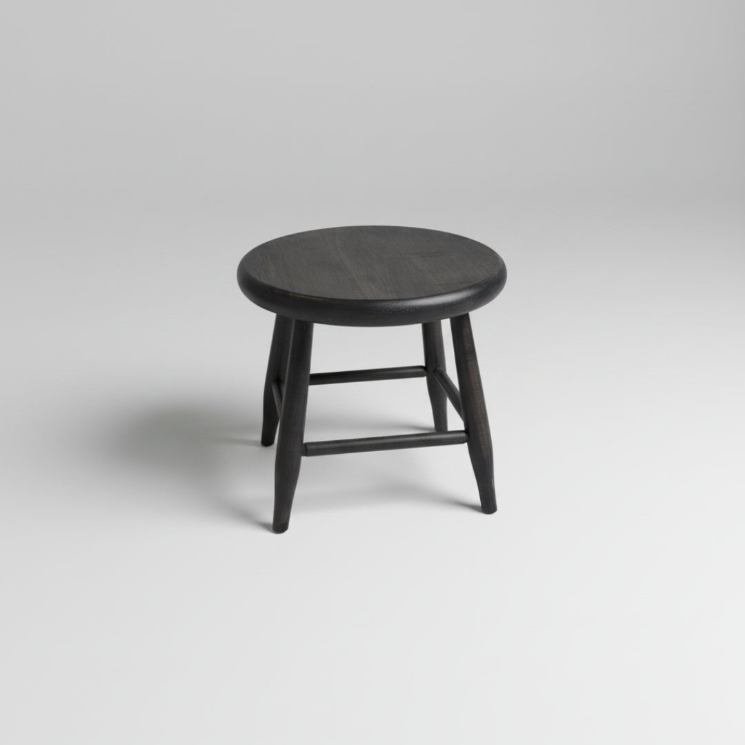 Round wooden stool with dark finish on a white background