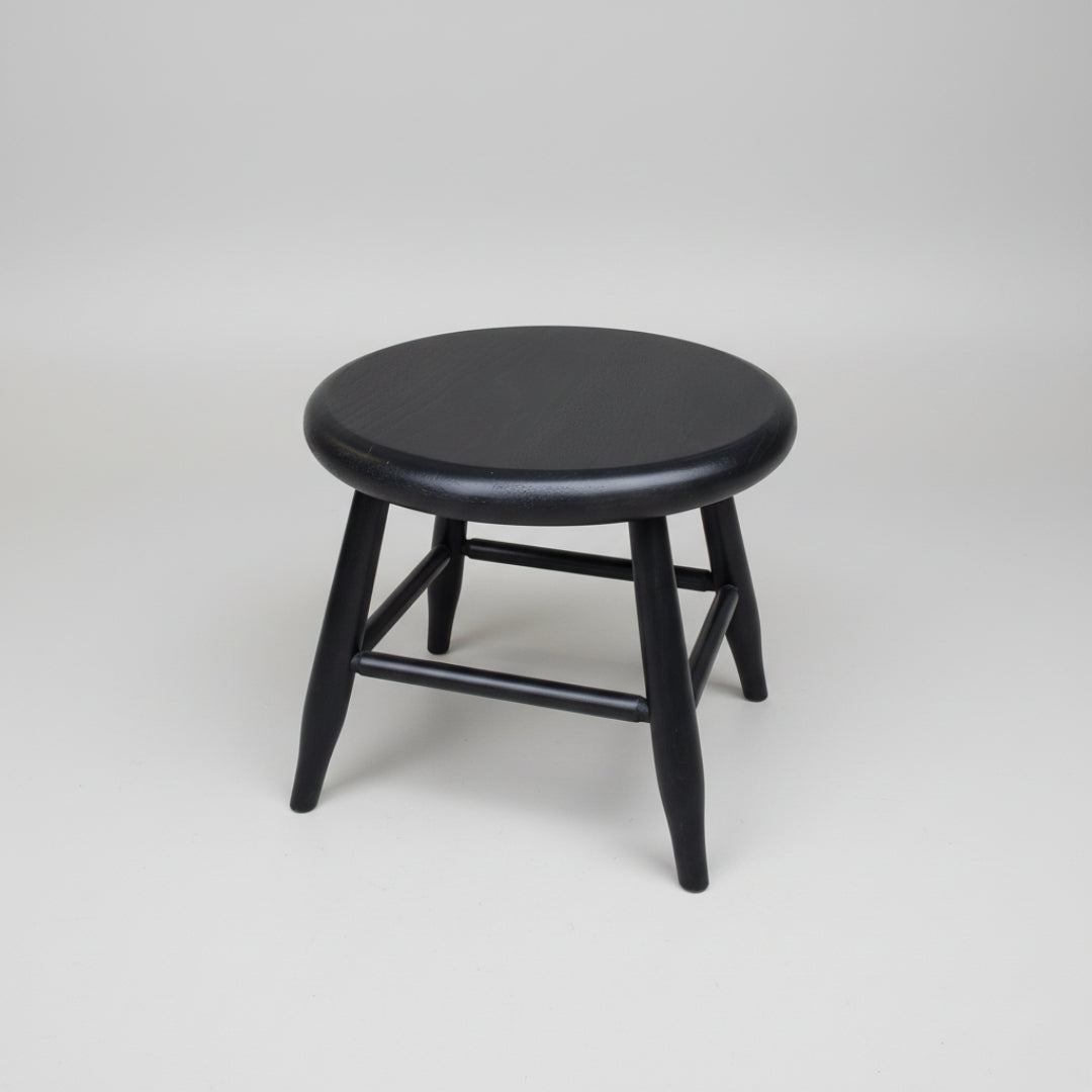 Black wooden stool on a white background