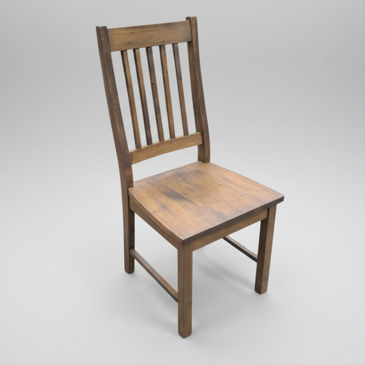 A rustic Mini Mission side chair with a wooden seat and backrest, constructed from solid wood.