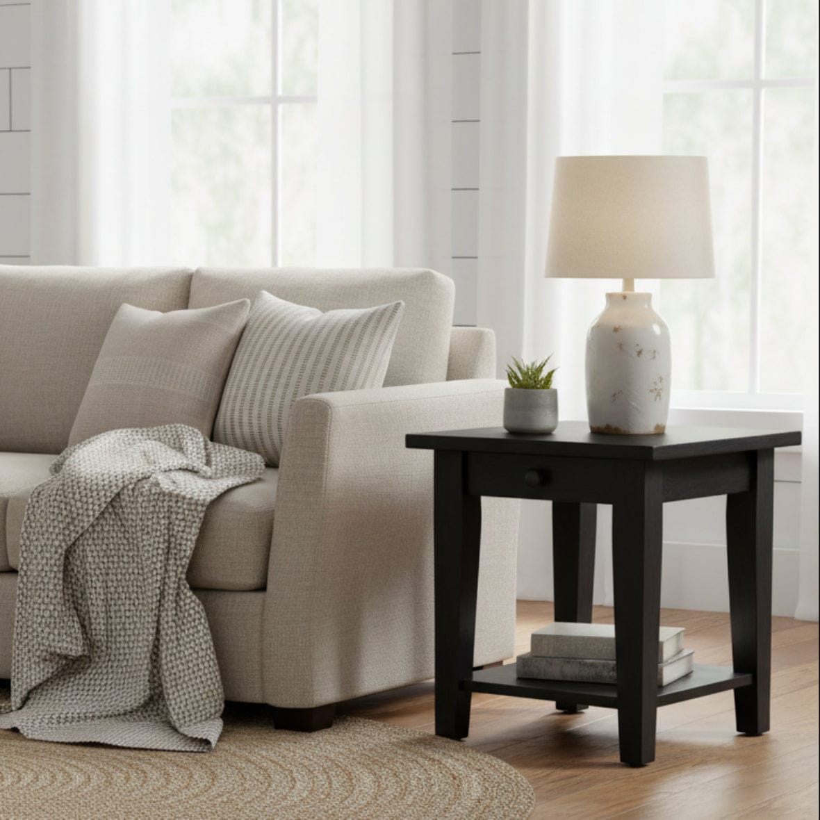 Black wooden side table with a drawer on a white background