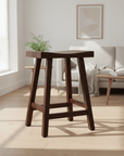 Wooden bar stool with curved seat on a white background