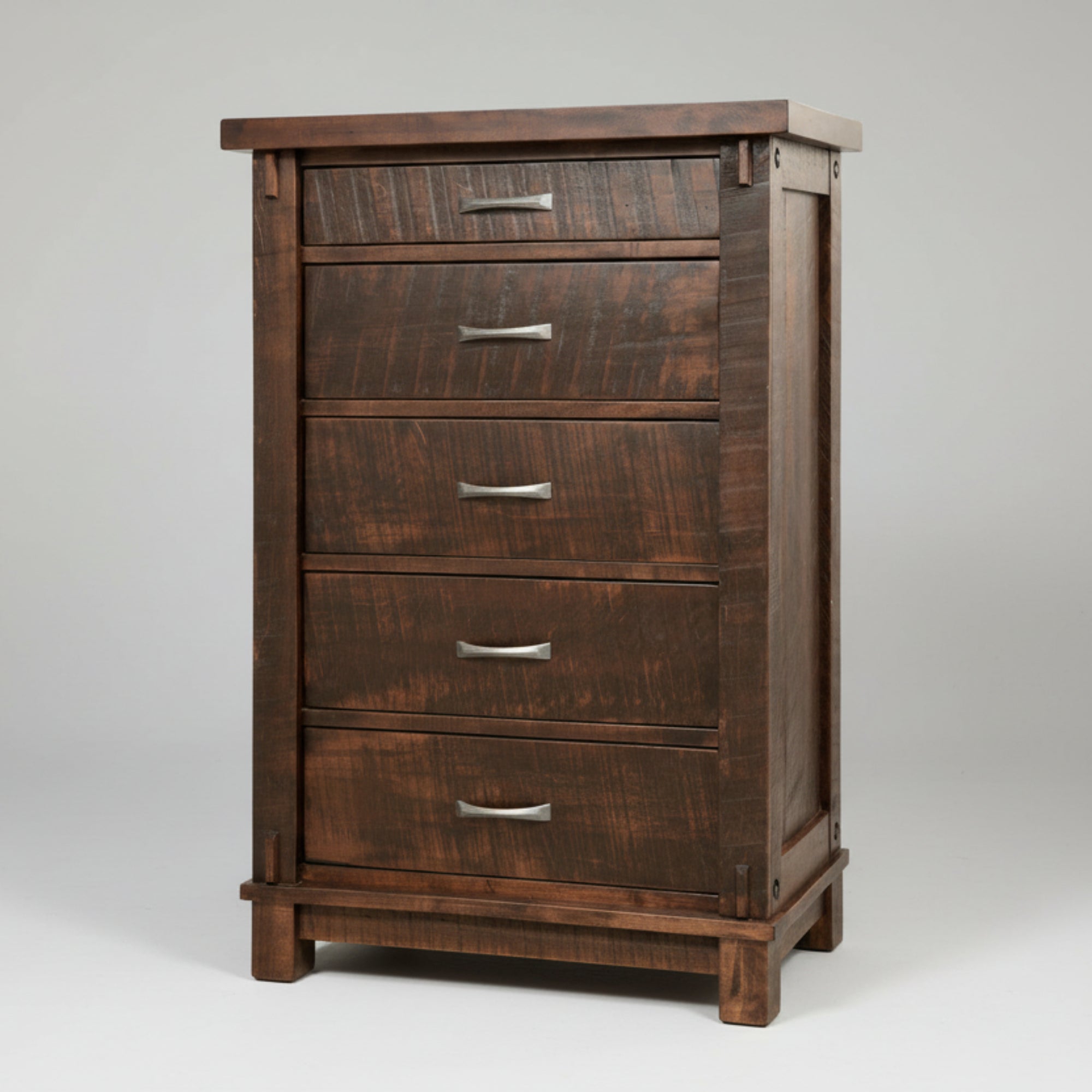 A brown wooden dresser with five drawers, featuring a millsawn texture and sturdy bolt accents.