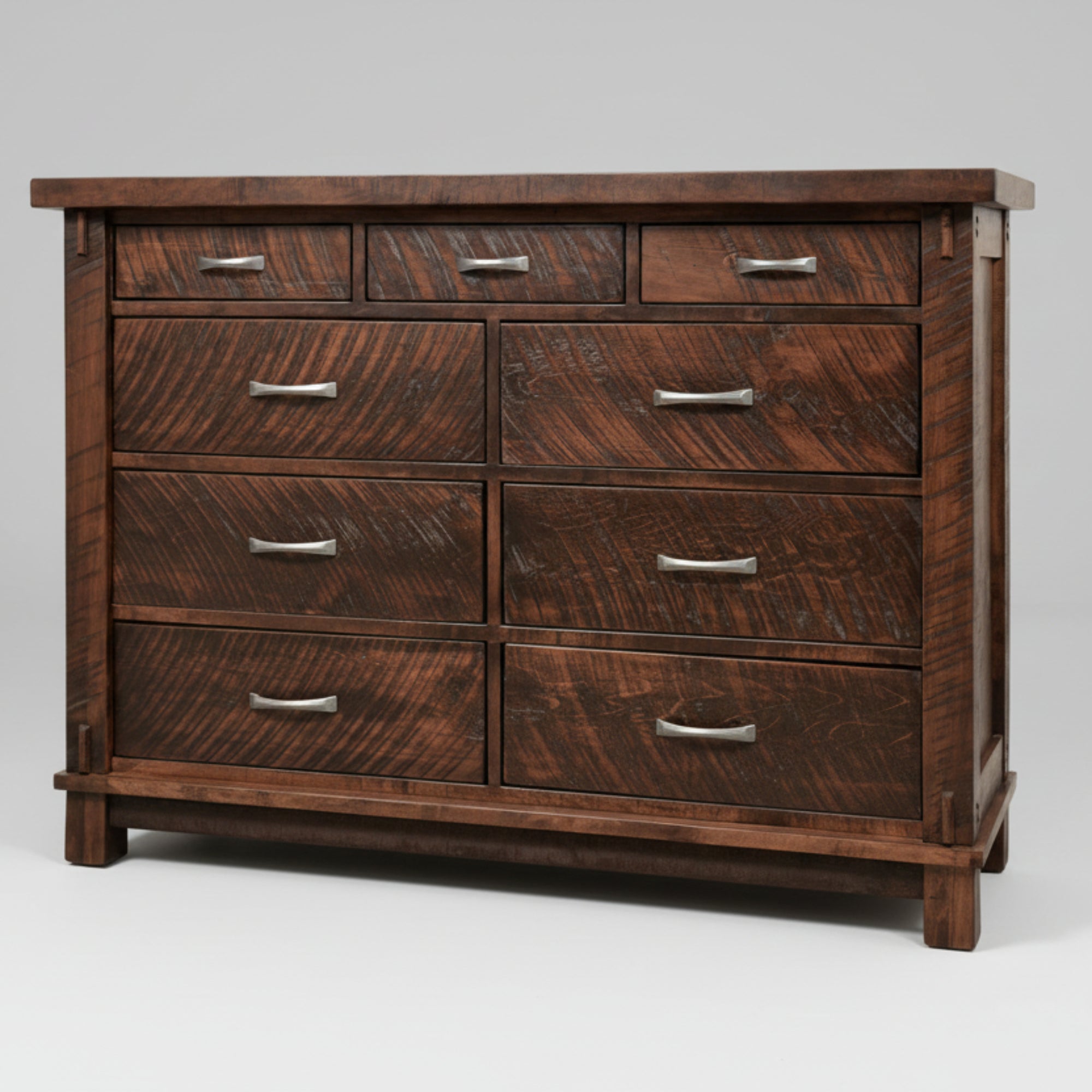A large, traditional wooden dresser with nine drawers, featuring metal handles and a millsawn texture finish.