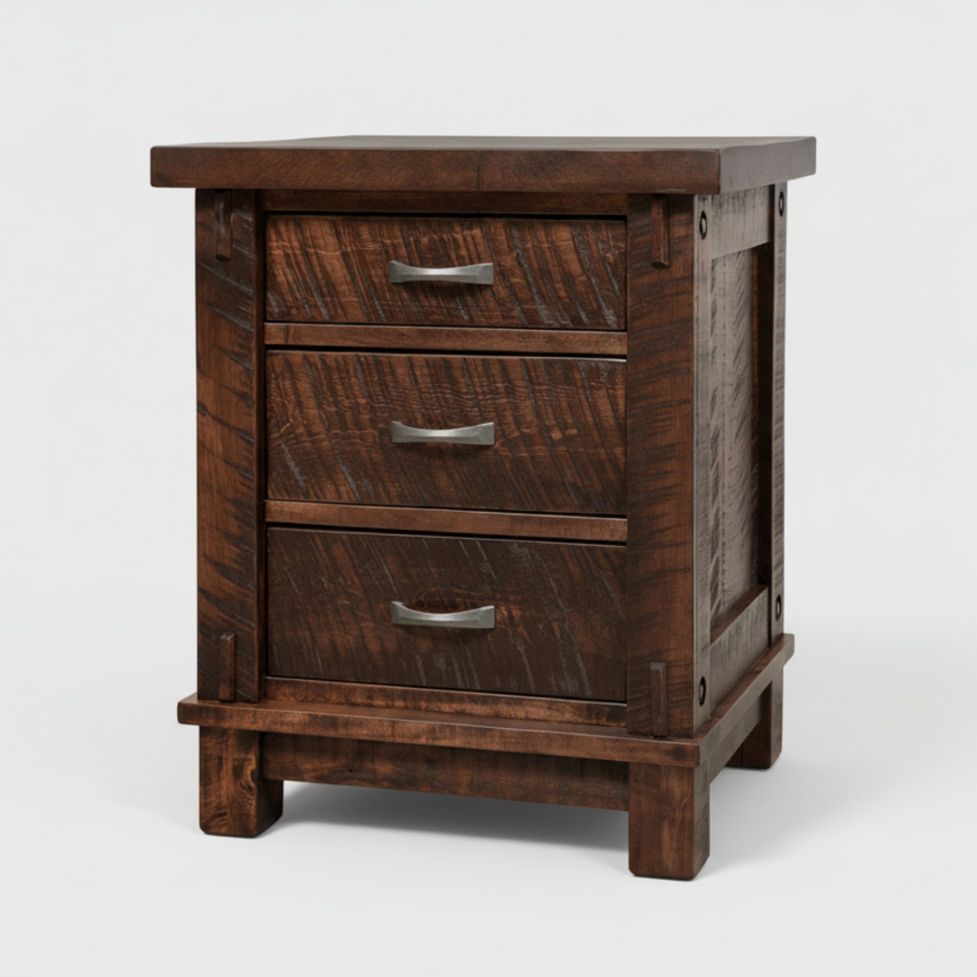 A Canadian made rustic Timber nightstand with three drawers, featuring millsawn wood texture and bolt accents, in a dark brown color.