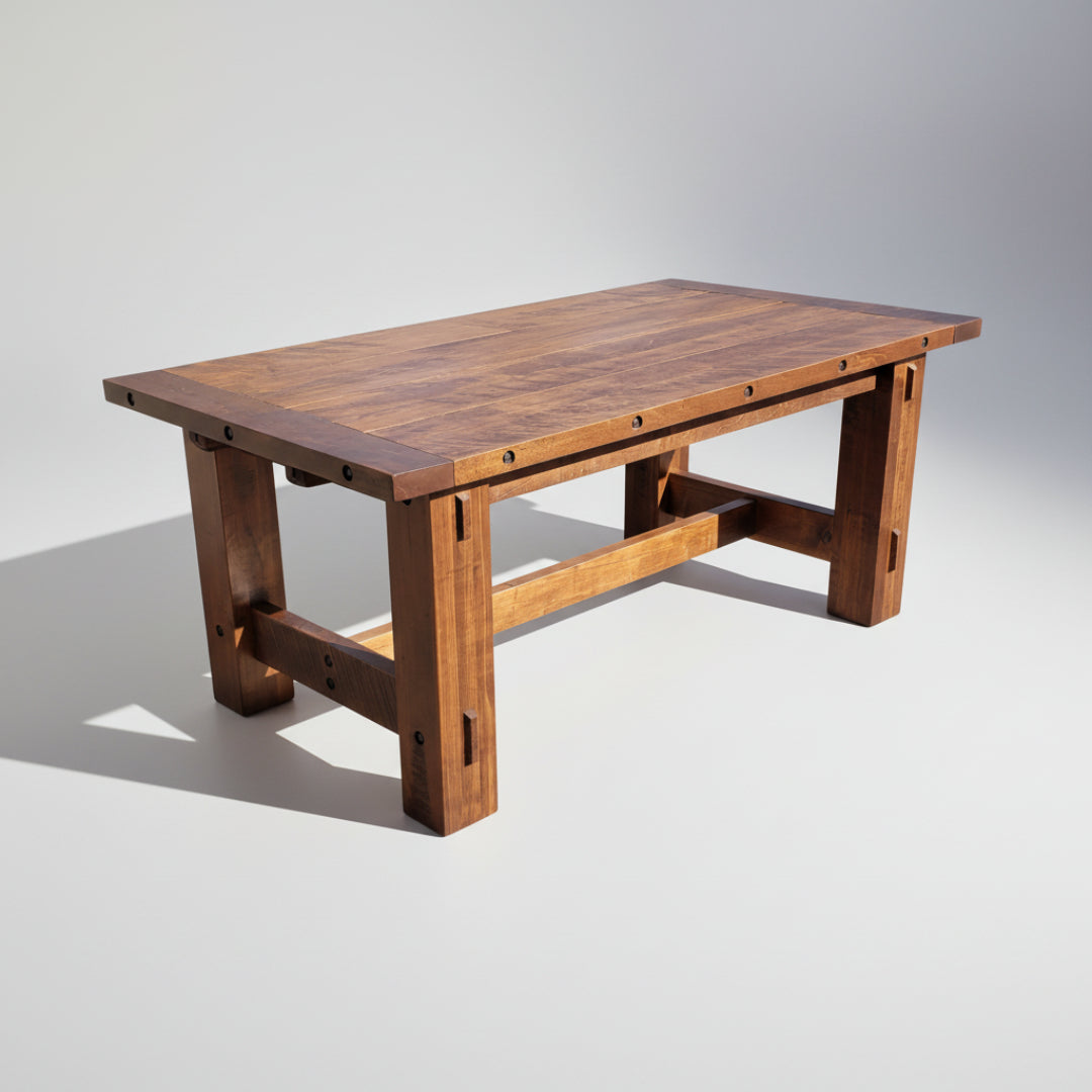 A rectangular Timber Trestle Table with a solid wood construction and bolt accents on the edges.