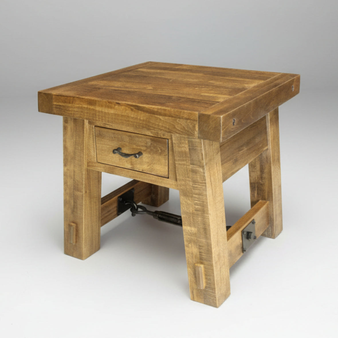 Wooden side table with a drawer on a white background