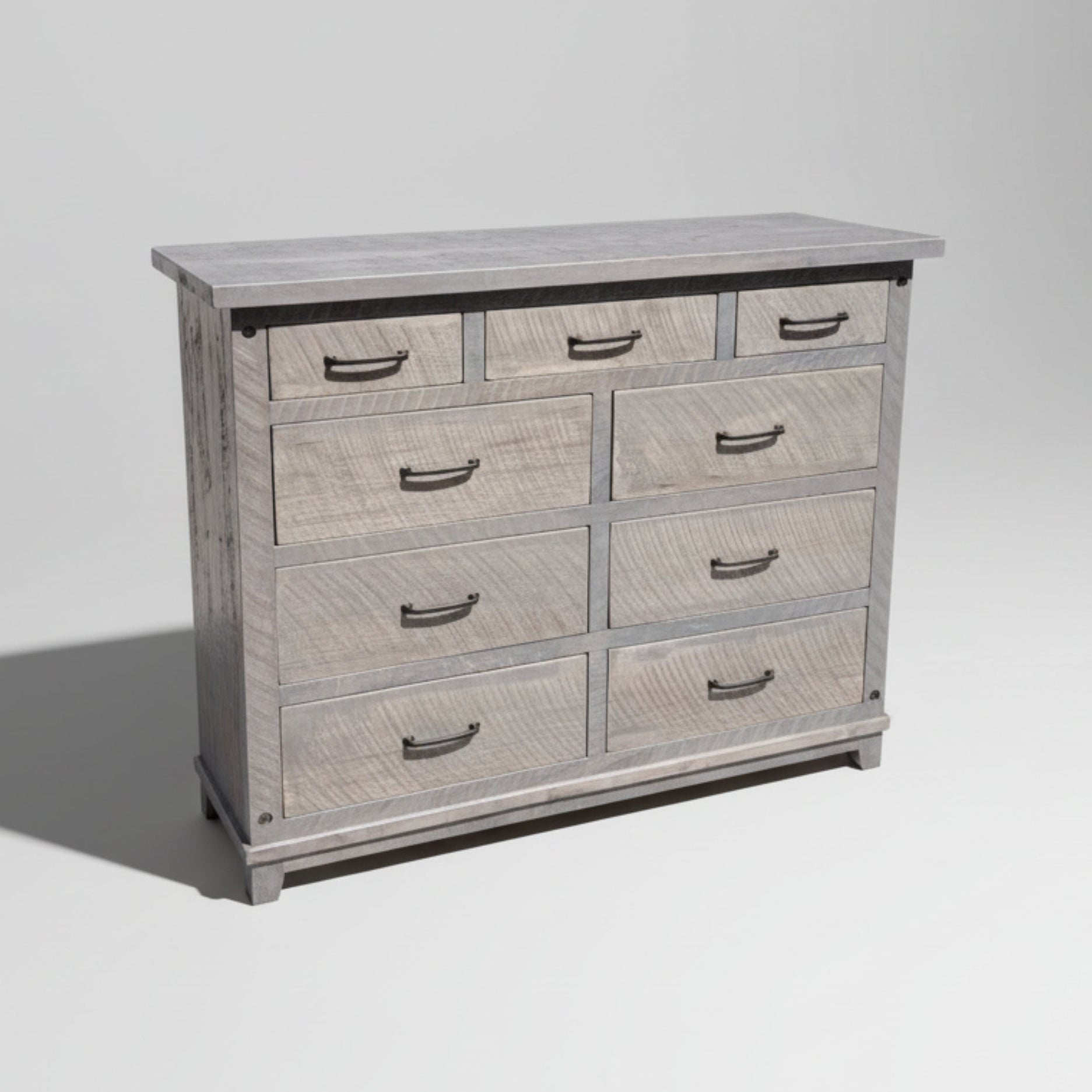 A rustic Adirondack style dresser with nine drawers, featuring bolt accents and a millsawn wood texture.