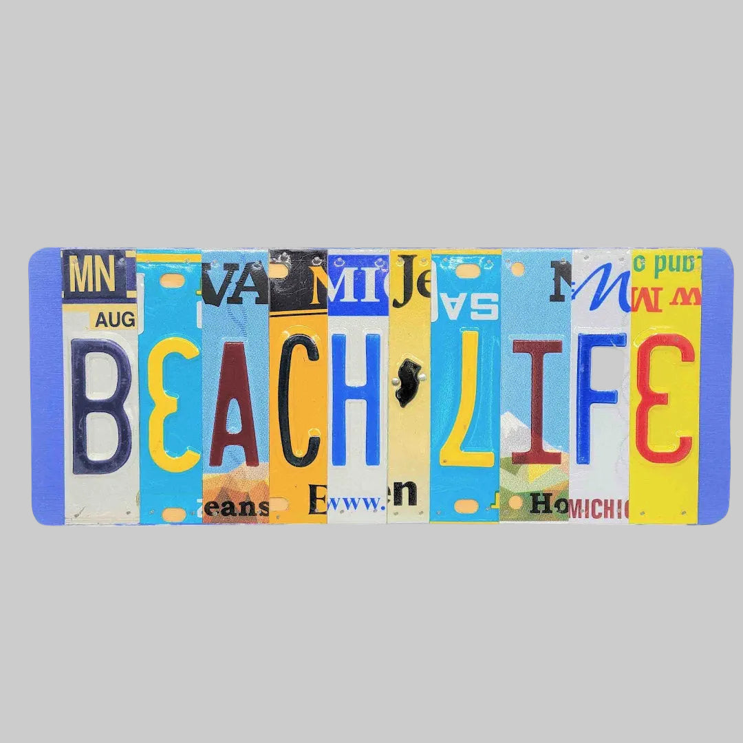 A rectangular decorative wall sign spelling 'BEACH LIFE' using colorful vintage license plate letters on a white background.