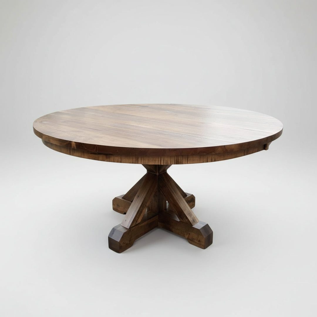 A round Brewster Pedestal Table with a wood finish and a sturdy X base style pedestal support.