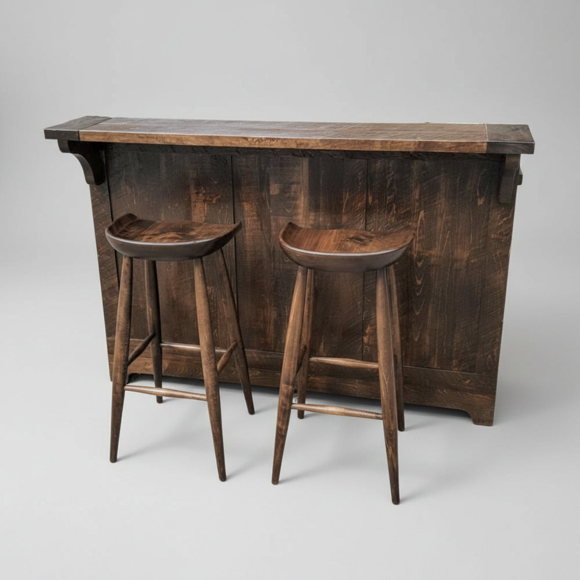 A rustic Century Split Level Bar made of solid wood, featuring a counter, two bar stools, drawers, shelves, and a wine rack.
