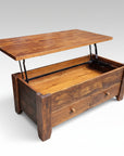 A rustic Dakota Pop Up Coffee Table made of solid wood, featuring a lift-top mechanism with visible saw marks and a wooden knob pull.