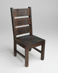 A wooden chair with a solid back and seat, possibly made of pine, with a dark brown finish.