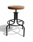 A swivel stool with a brown wooden seat and black metal base and footrest.