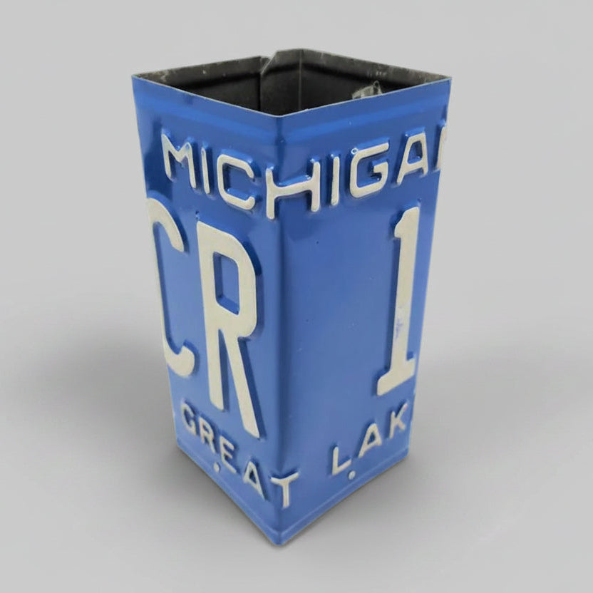 A square metal container or planter styled like a vintage Michigan CR 1 Great Lakes license plate, featuring a blue background with raised white lettering, shown on a plain light gray background.