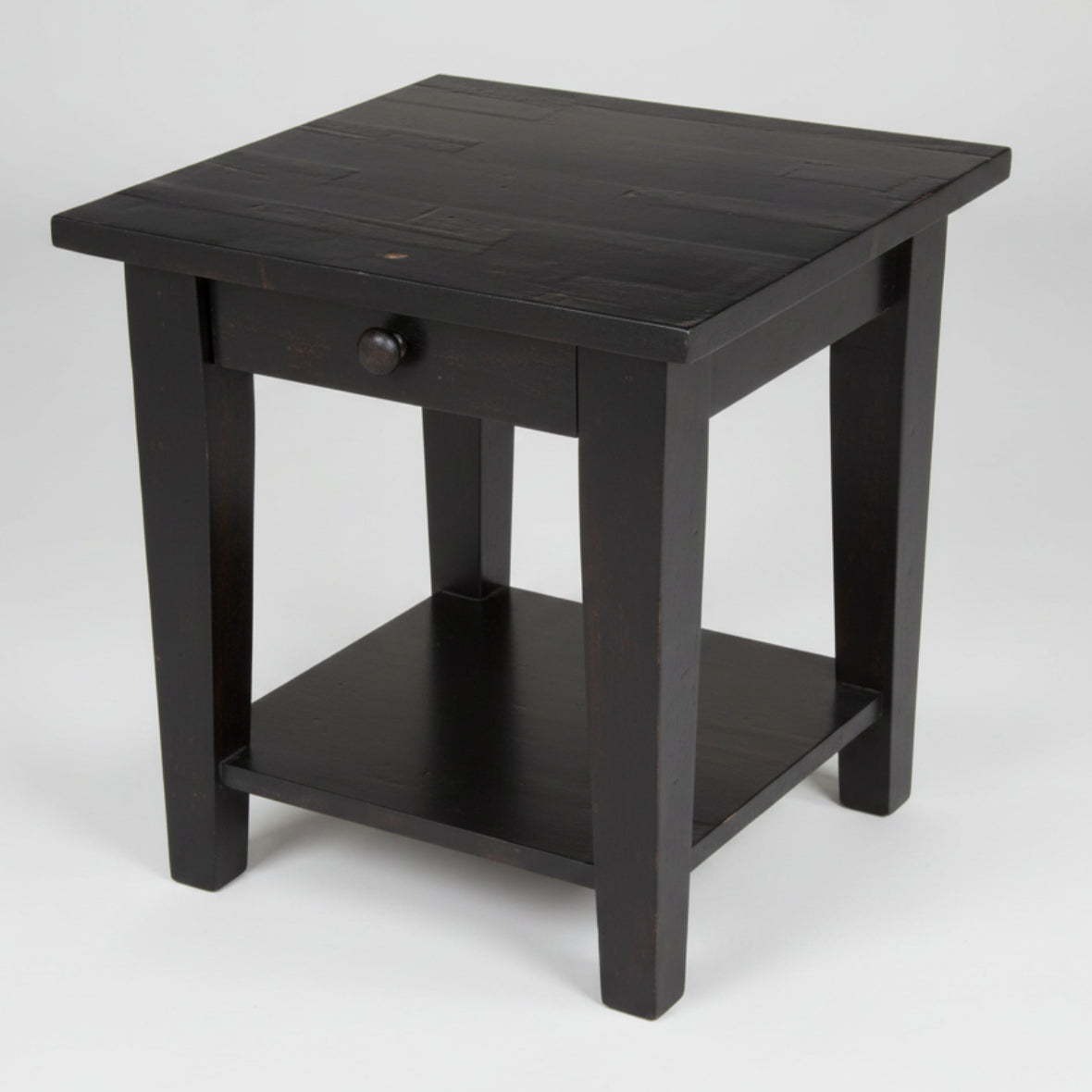 A black Nith River end table with one drawer and a lower shelf, featuring a square top and tapered legs.