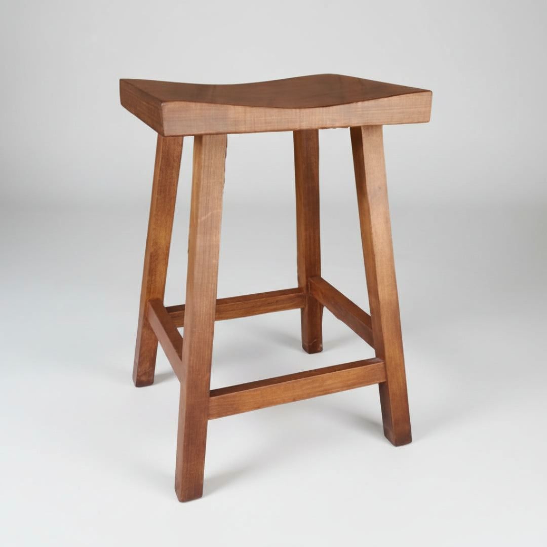 A brown wooden Shaker saddle stool with a smooth texture finish and a scooped seat design.