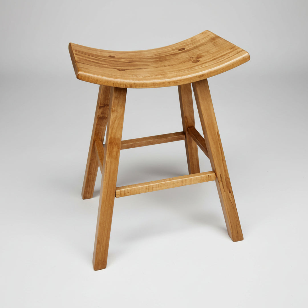 A square saddle stool with sturdy square legs and a curved seat made of Canadian solid wood.