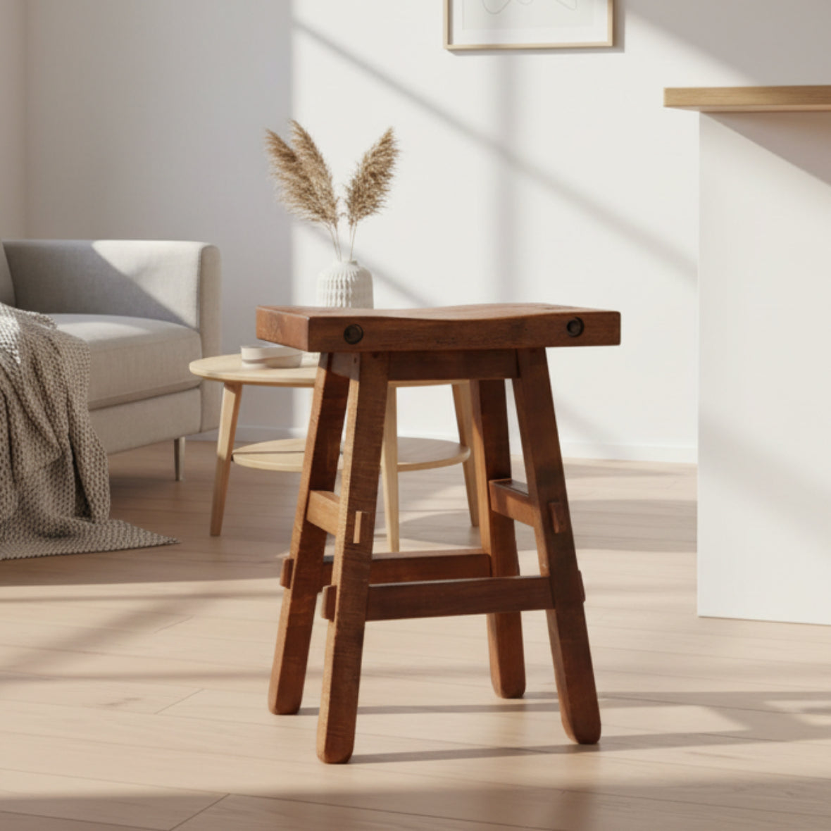 A brown wooden timber stool with a scooped seat and bolt accents, Canadian-made.