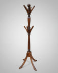 A wooden hall tree with a turned design, featuring multiple hooks at the top, a smooth wood texture, and a brown finish.