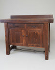 A wooden sideboard with a unique metal turnbuckle design, featuring two drawers and two doors, finished in a rustic style.